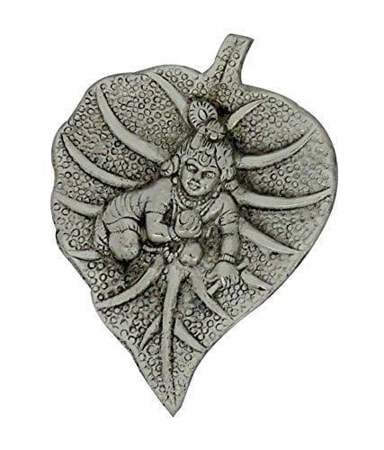 white metal wall hanging of laddu gopal on leaf (10186)